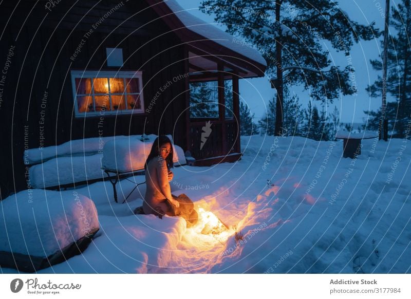 Naked woman sitting beside fire in snow Woman Snow Bonfire Mysterious Fire Twilight Purity Eroticism Tattooed Pensive White Charming Winter