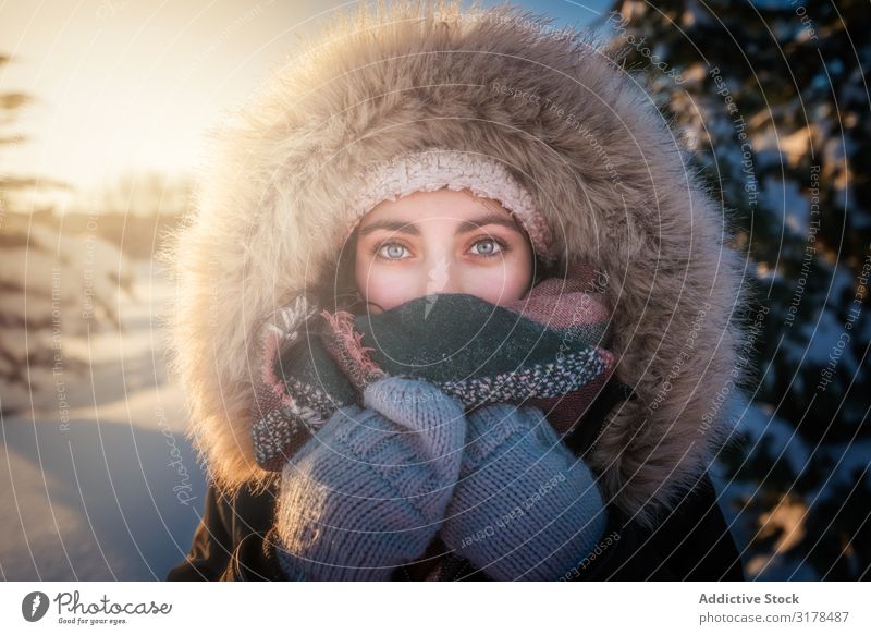 Portrait of a young woman in winter clothes and a hat wrapped in a scarf  with a big smile - a Royalty Free Stock Photo from Photocase