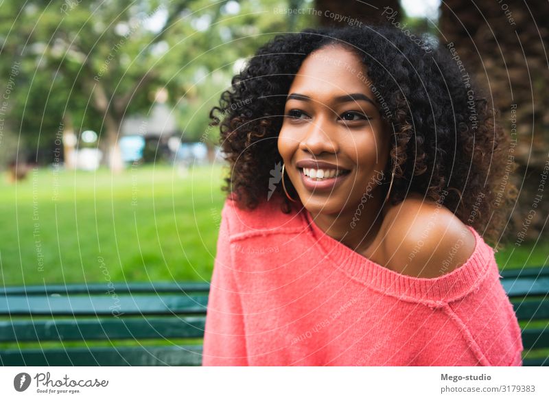 Afro-american woman sitting in the park. Lifestyle Happy Beautiful Relaxation Garden Human being Feminine Woman Adults Nature Park Brunette Smiling Happiness