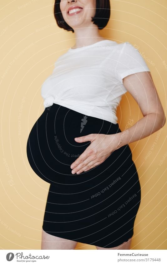 Urban young pregnant woman - neutral background Feminine Woman Adults 1 Human being 18 - 30 years Youth (Young adults) 30 - 45 years Happy Pregnant Offspring