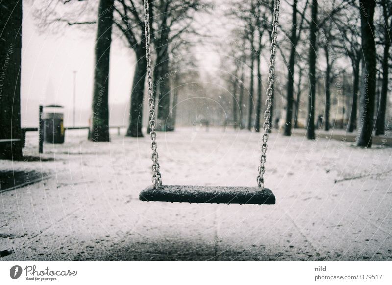 Deserted playground in winter Winter Playground Swing Theresienwiese Munich Exterior shot Snow Loneliness Calm Cold Infancy Colour photo Park Gloomy To swing