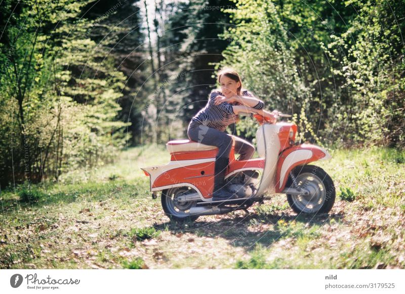Young woman on vintage scooter 49cc Mobility Lifestyle Exterior shot Means of transport forest path Forest Nature Retro Vintage car moped Analogue photo Kodak