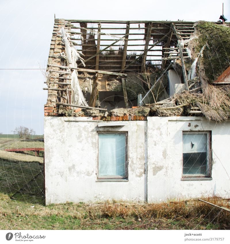 Roof damage in the holiday home lost places GDR Winter Meadow Rügen Architecture Thatched roof house Window Wooden roof Reet roof Cold Broken Retro