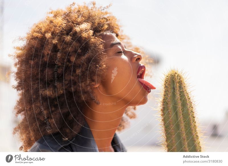 Black woman pretending to lick cactus Woman Lick Passion Closed eyes Cactus Eroticism Desire African-American Conceptual design Youth (Young adults) Alluring
