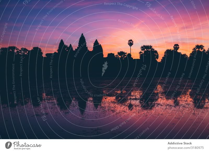 Bright sunset sky over temple and lake Temple Lake Sunset Sky Evening Clouds oriental Silhouette Calm Vacation & Travel Landmark Water Tourism Asia Angkor Wat