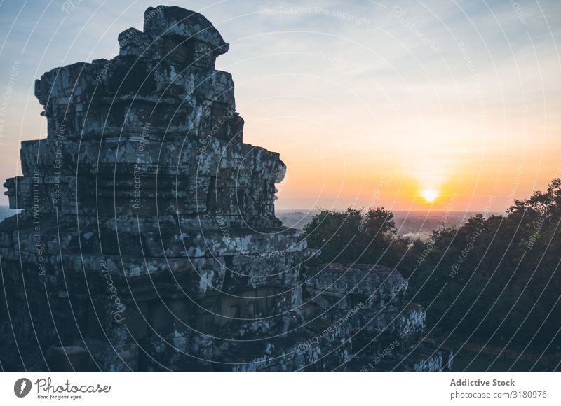 Ancient temple against sunset sky Temple Sunset Sky Evening Vantage point Weathered Ruined Architecture Angkor Wat Landmark Vacation & Travel Trip oriental