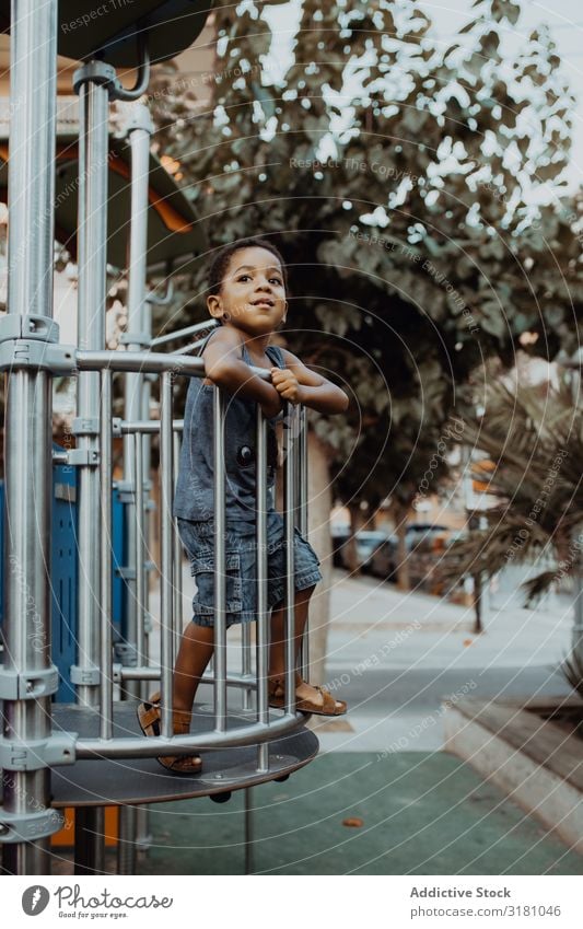 Funny black boy on playground Boy (child) Playground Park Black Grating Child Small Cute Playing Lifestyle Leisure and hobbies Rest Relaxation Entertainment