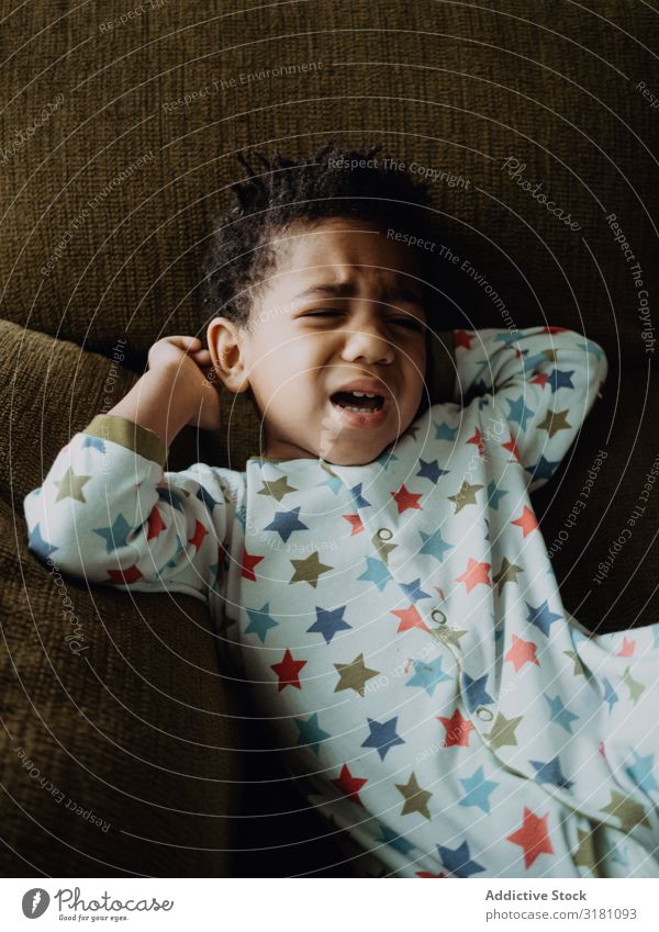 Black child ready to cry Boy (child) Cry Sofa Home pajamas Sadness Room Small Child African-American Ethnic Problem Toddler Cute Delightful Lovely Grimace Couch