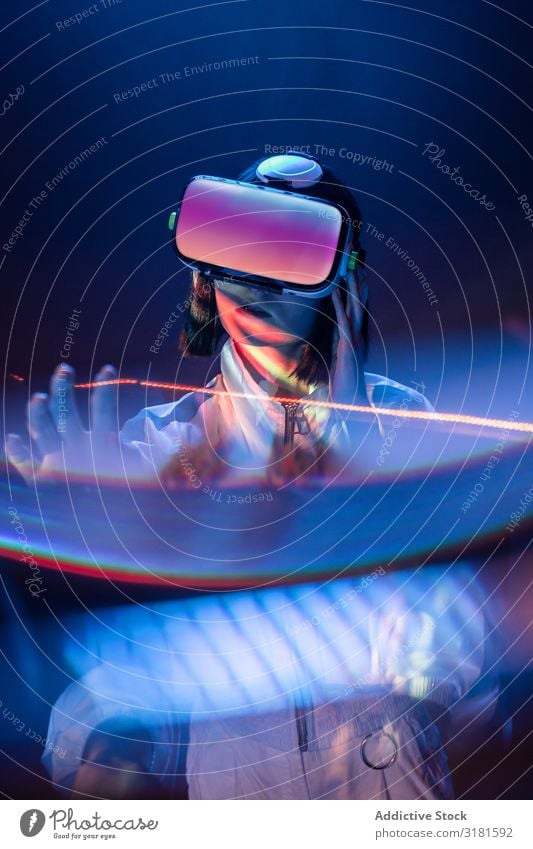 Woman touching air in VR glasses vr asian Headset virtual reality Technology Neon Light Touch Air device Digital innovation Person wearing glasses Modern