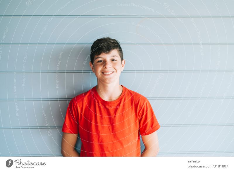 Cheerful male teen leaning on wall while looking camera Lifestyle Joy Happy Face Camera Human being Masculine Boy (child) Man Adults Teeth 1 8 - 13 years Child