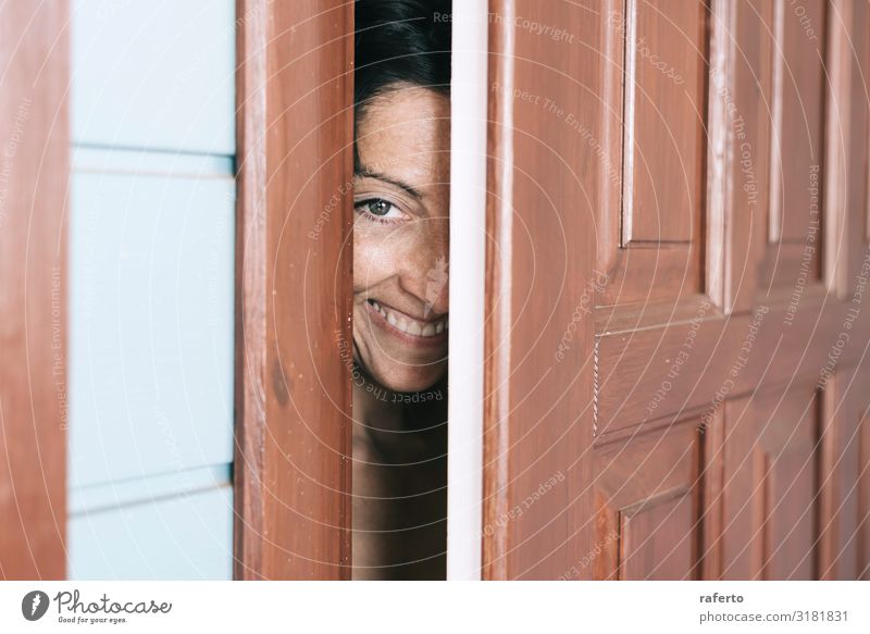 Smiling woman looking between open door and wall Lifestyle Elegant Human being Feminine Young woman Youth (Young adults) Woman Adults 1 30 - 45 years Fashion