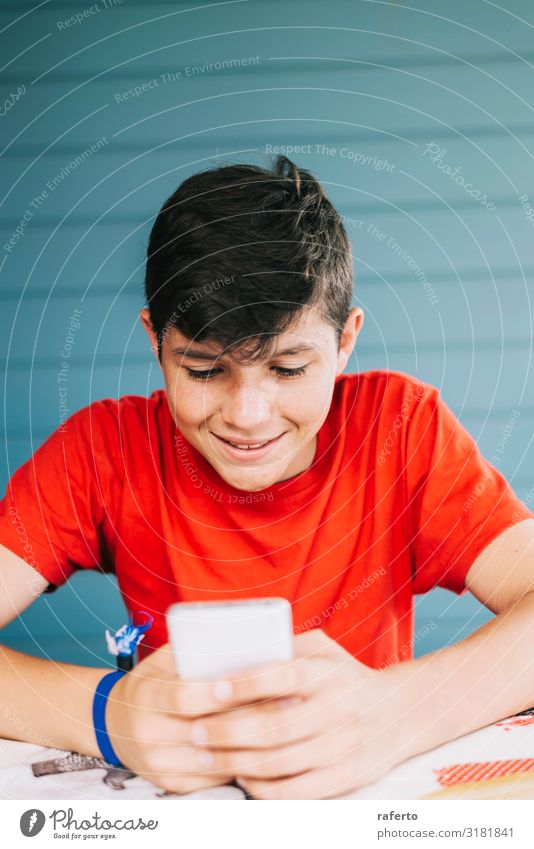 Boy wearing red t-shirt sitting outdoors using phone Lifestyle Happy Leisure and hobbies Telephone Cellphone PDA Technology Human being Masculine Boy (child)