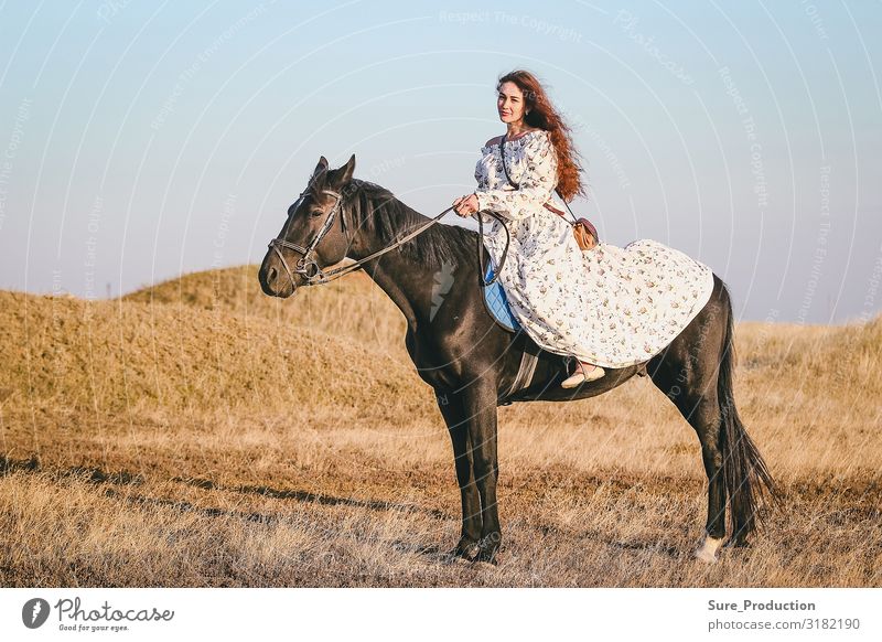 young woman in medieval dress on horse on horizon background Leisure and hobbies Woman Adults Art Theatre Actor Horizon Dress Brunette Horse Cool (slang)