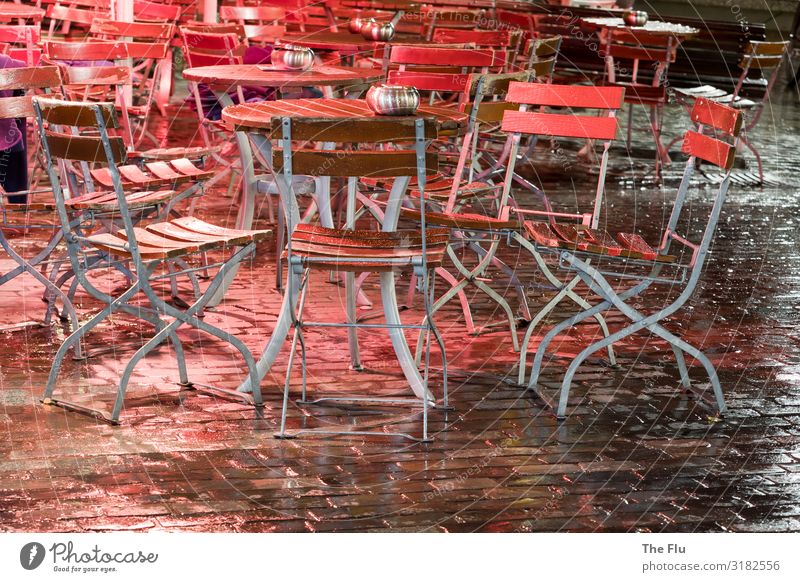The long wait for guests Beer Wine Rain Downtown Old town Deserted Cobblestones Wait Brown Red Black Silver Table Chair Beer garden Wet Damp Wood Metal
