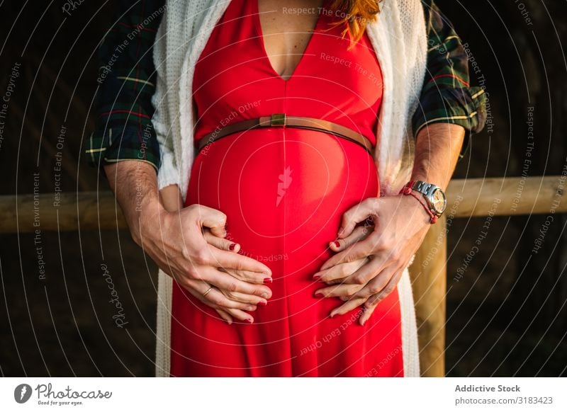 Crop man touching belly of pregnant woman Couple pregnancy Showing one's bellybutton Touch Man Woman Delicate Affection To enjoy Love tender Family & Relations