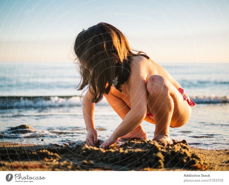 Cute Little Girl Playing With Sand At Beach A Royalty Free Stock Photo From Photocase