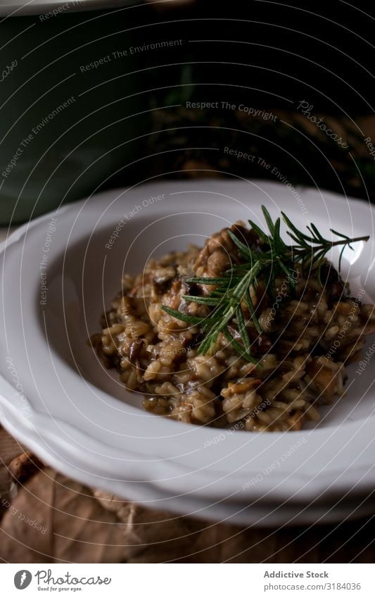 Rosemary on risotto with rabbit and mushrooms Rice Hare & Rabbit & Bunny Mushroom Plate Table Kitchen Rustic Dish Dinner Food Meat Italian Herbs and spices
