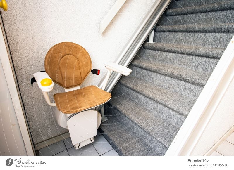Automatic stair lift on staircase taking elderly and disabled Lifestyle Design Flat (apartment) House (Residential Structure) Chair Human being Building