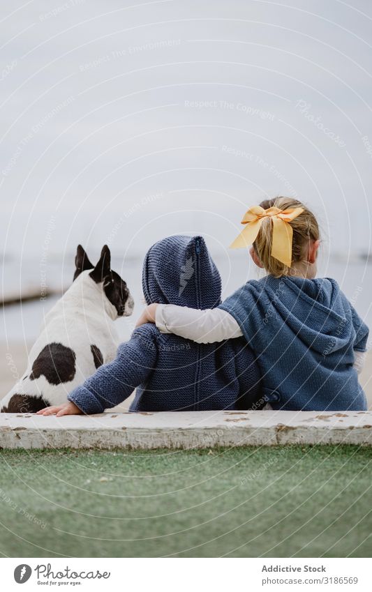 Kids hugging dog on beach Child Dog Beach Friendship Love Embrace Pet Ocean Sit Obedient Baby french bulldog Easygoing Lifestyle Leisure and hobbies embracing