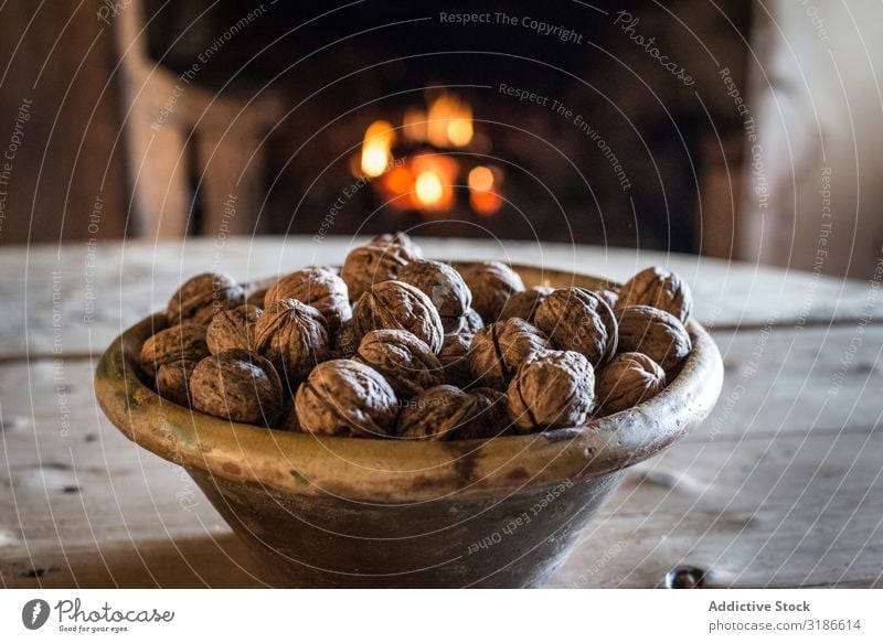 Bowl of nuts on table in old cottage Old House (Residential Structure) Nut Fireplace Comfortable Kitchen Interior design Cottage Village Landscape Rural Ancient