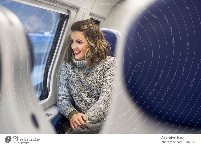 young woman looking through window in train Railroad Window Cheerful Woman Happy looking out Youth (Young adults) Girl Passenger Vacation & Travel Transport