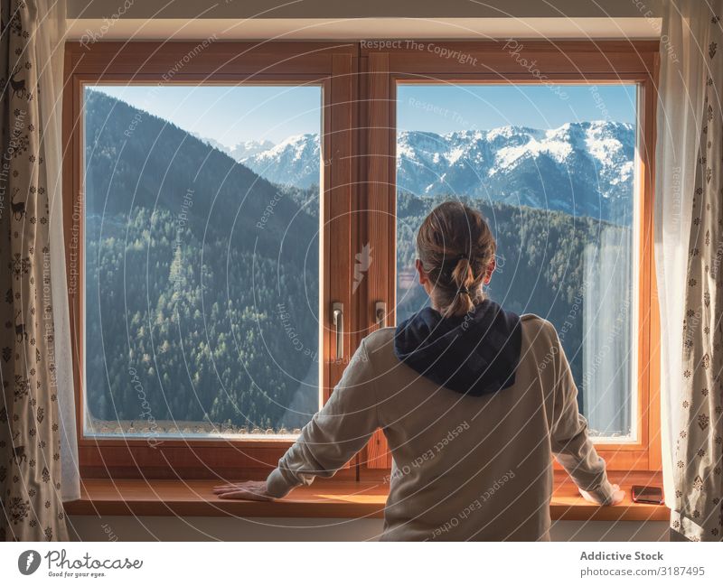 Anonymous woman looking at mountains from window Woman Mountain Window admiring Lean sill Home Sunbeam Day Recklessness Nature Landscape Lifestyle