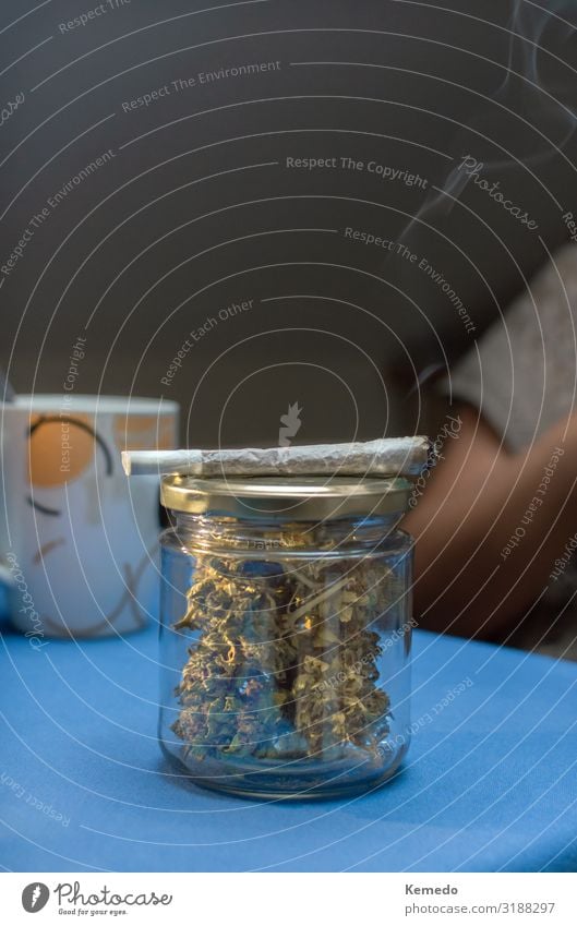 Glass jar full of cannabis buds and a marijuana joint. Hot drink Coffee Espresso Pot Lifestyle Health care Medical treatment Alternative medicine Smoking