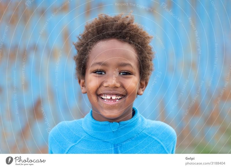 Funny african child with blue jersey Joy Relaxation Leisure and hobbies Playing Child Boy (child) Infancy Autumn Meadow Afro Smiling Dream Happiness Small Cute