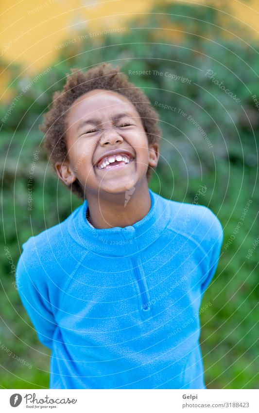 Happy african child with blue jersey Joy Relaxation Calm Leisure and hobbies Playing Garden Child Boy (child) Infancy Autumn Park Meadow Afro Smiling Dream