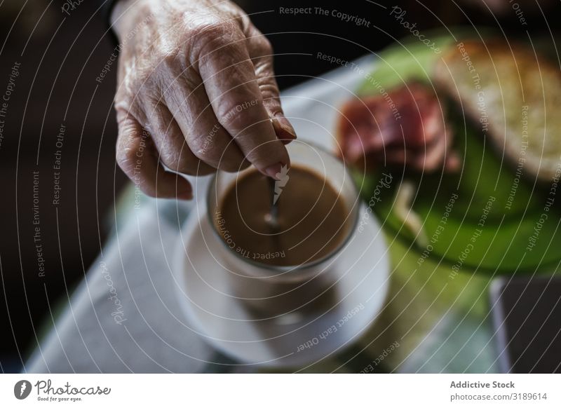 Hand of aged woman holding spoon in cup Stir Coffee Spoon Old Drinking Breakfast Beverage Cup Hot Food Morning Human being Woman Senior citizen Table Aromatic