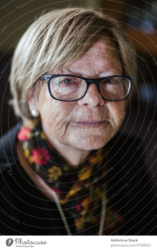 Elderly woman in glasses looking at camera Woman Old Wrinkled Portrait photograph kind Person wearing glasses Face Expression Home Cozy Mature Senior citizen