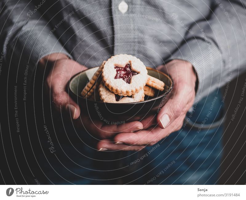 Man holding Christmas cookies in a bowl in his hands Food Dough Baked goods Cookie Christmas biscuit To have a coffee Bowl Lifestyle Christmas & Advent