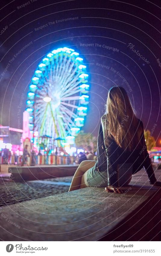 Young woman contemplating a Ferris wheel at night Joy Vacation & Travel Night life Entertainment Party Event Music Feasts & Celebrations Feminine