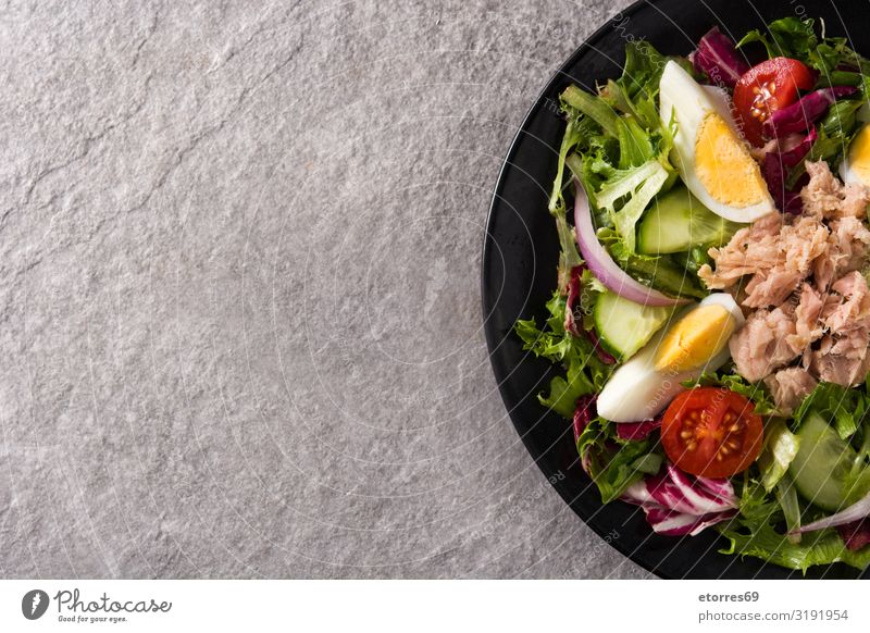 Salad with tuna, egg and vegetables Vegetable Tuna fish Egg Tomato Lettuce Black Plate Onion Cucumber Slice Mixed Olive oil Healthy Eating Food Food photograph