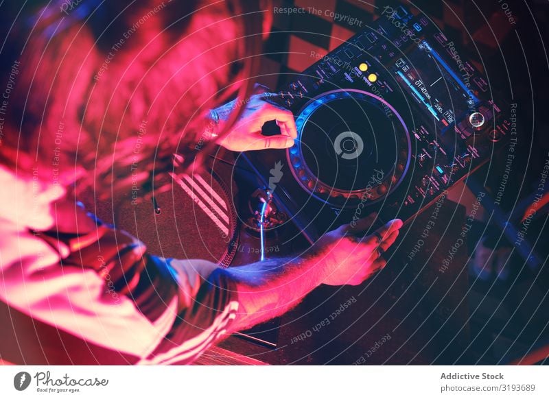 From above an anonymous dj man playing in a club with lights Nightclub Hand Entertainment Record Playing Equipment Turntable Party disc Background picture Club