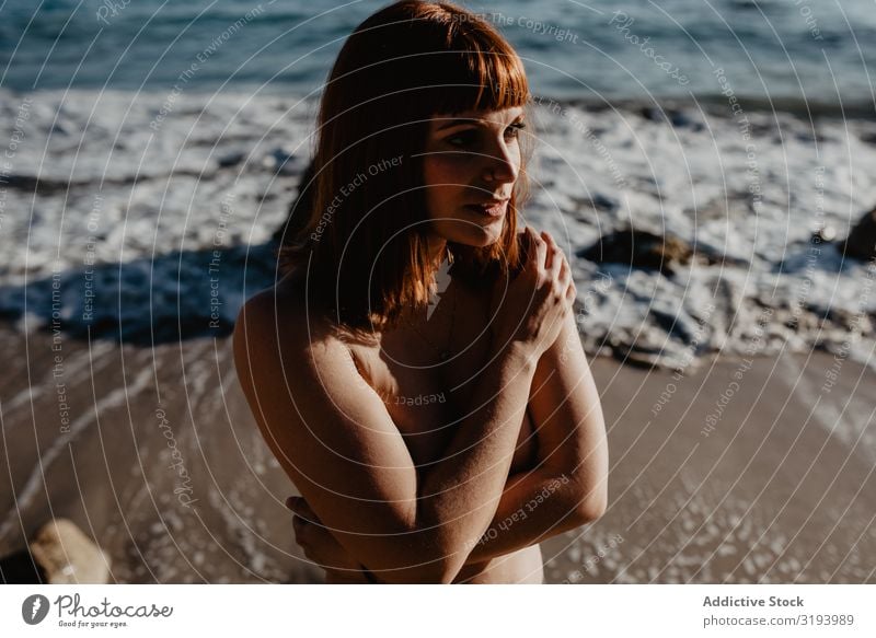 Sensual woman posing on seashore Woman Posture topless Coast To enjoy Ocean Sunbeam Day Breasts Harmonious Idyll Lifestyle Leisure and hobbies Rest Relaxation