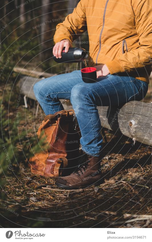 tea break Hot drink Masculine 1 Human being Hiking Nature Forest Sit Exterior shot Break Tea Thermos coffee pot Pour Unload Heat Tree trunk Backpack Trip