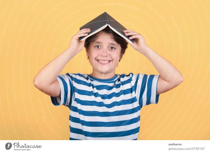 happy child with book on head Lifestyle Joy Playing Reading Child School Study Schoolchild Human being Masculine Infancy 1 8 - 13 years Book Smiling Laughter