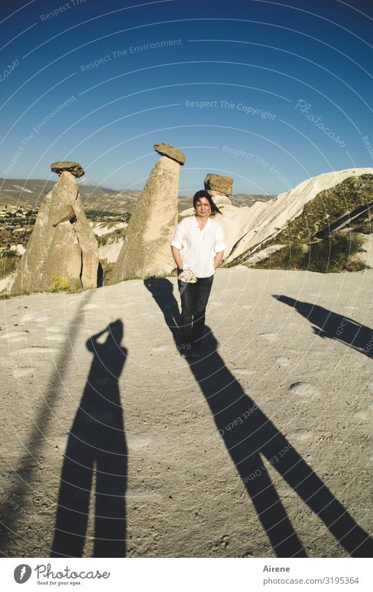in the middle Woman Adults 1 Human being 30 - 45 years Cloudless sky Beautiful weather Rock Tufa Miracle of Nature Erosion Cappadocia Tourist Attraction