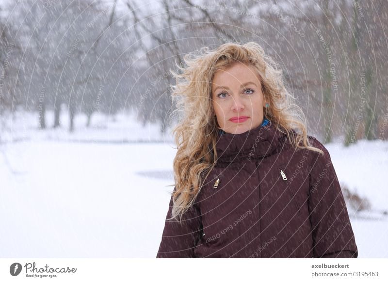 Woman in heavy snowfall in the park Lifestyle Leisure and hobbies Trip Winter Snow Winter vacation Human being Adults 1 30 - 45 years Nature Climate