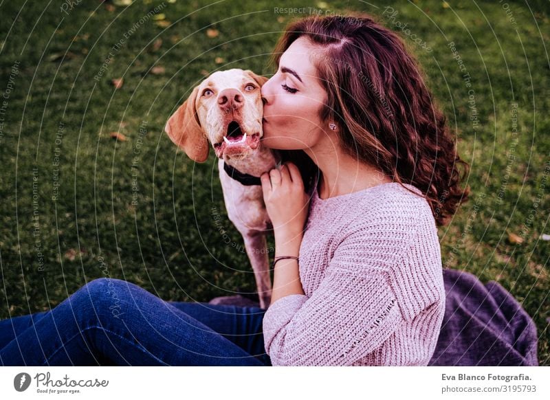 young woman with her dog at the park. she is kissing the dog. autumn season Portrait photograph Woman Dog Park Youth (Young adults) Exterior shot Love Pet owner
