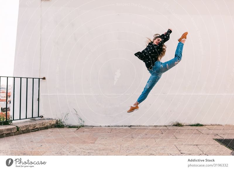 Teen dancer jumping against white wall Woman Jump Dance Splits Fly Freedom Skyline Street grace Recklessness Inspiration Youth (Young adults) pose Action skill