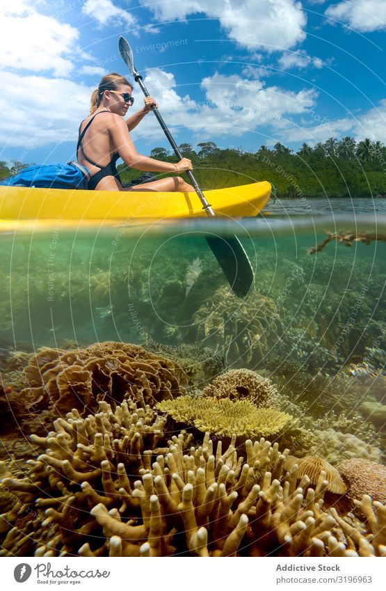 Sportive woman traveling on canoe in tropical lagoon Woman Canoe Lagoon Tropical Athletic Traveling Tourist Kayak Bottom Picturesque Coral Youth (Young adults)