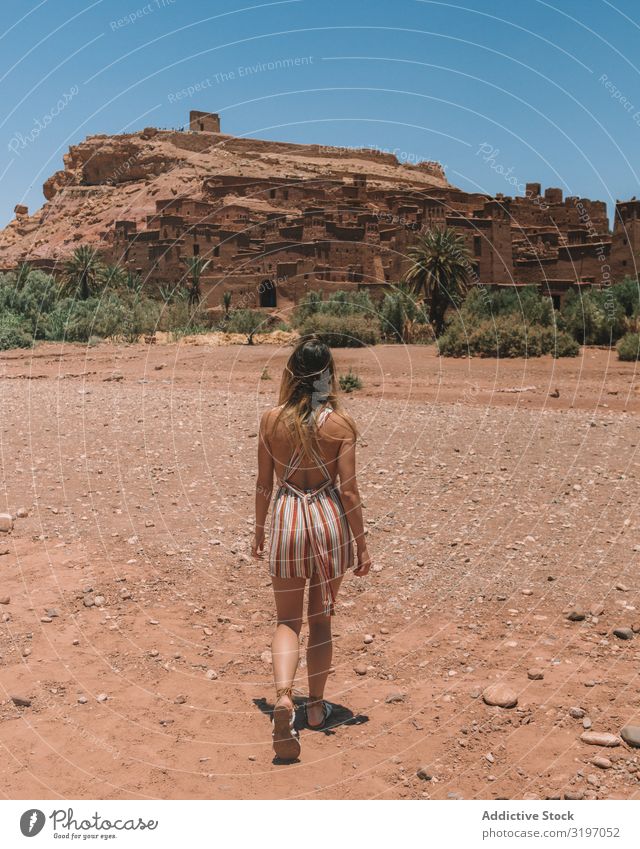 Woman walking in desert with ancient city Desert City Morocco Rock Ancient Walking explore Vacation & Travel Tourism Summer Landscape Sand Nature Destination