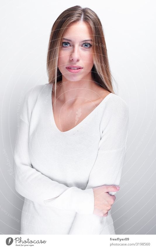 Shy woman looking at camera on a white background Joy Happy Beautiful Face Human being Young woman Youth (Young adults) Woman Adults 1 18 - 30 years Sweater