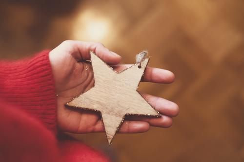 A person holding a wooden star in his hand; Christmas, Advent Christmas & Advent Christmas tree decorations Feminine Christmas decoration by hand Authentic