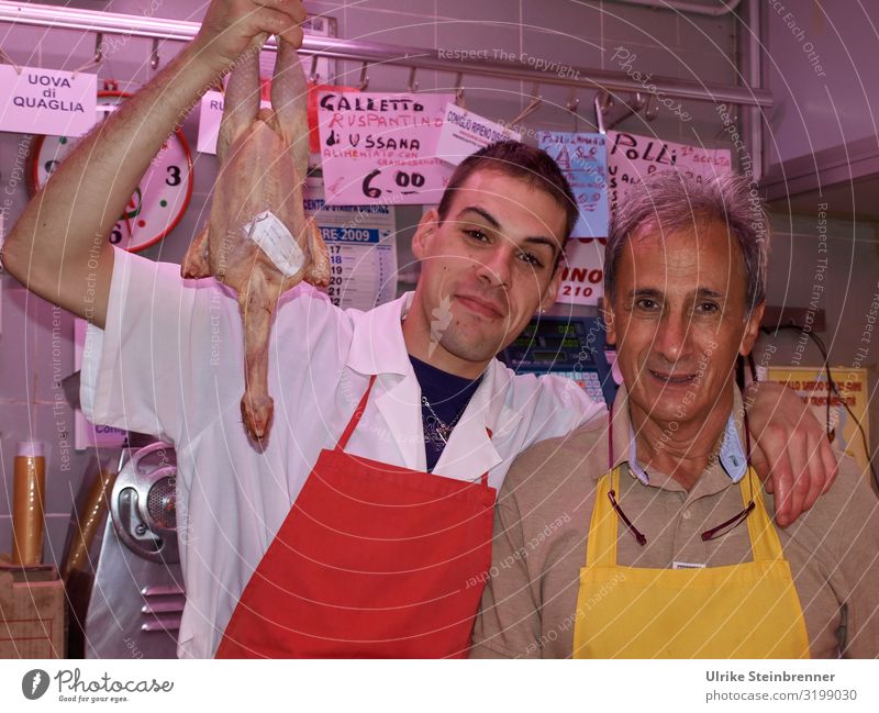 Father and son sell freshly slaughtered poultry in the market hall Food Meat Poultry Barn fowl Nutrition Italian Food Shopping Vacation & Travel Tourism