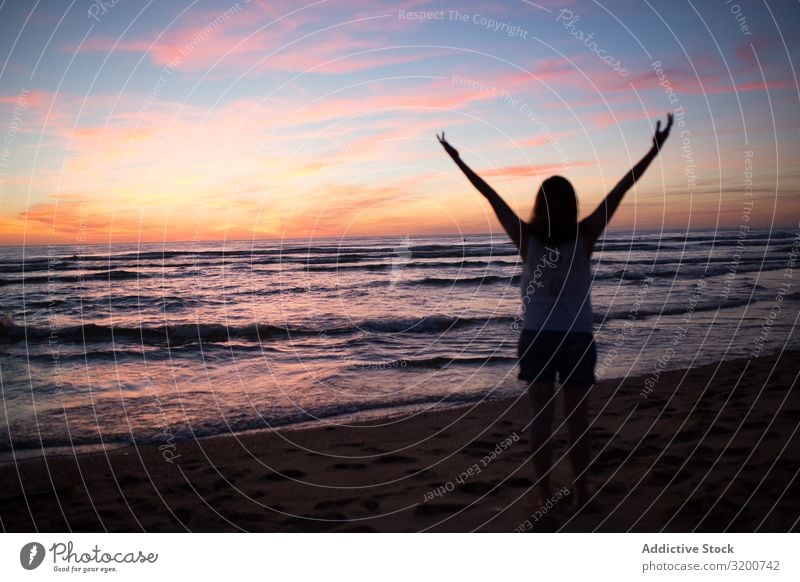Female tourist posing on seaside at sunset Tourist Sunset Woman Posture Gesture Heart Beach Sand Picturesque Sky Walking Vacation & Travel Lifestyle