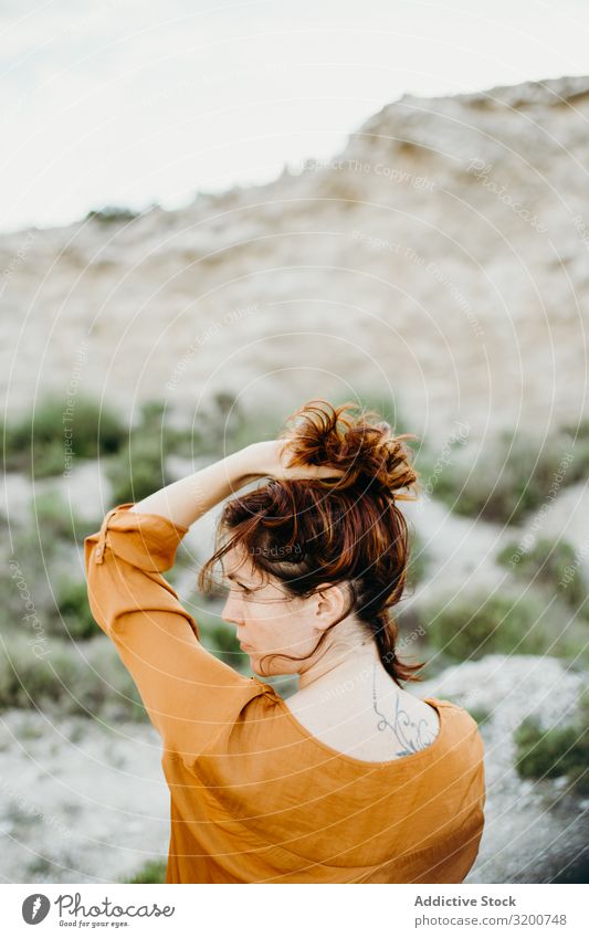 Dreamy attractive young woman posing outdoors Woman Posture Attractive Youth (Young adults) Model Portrait photograph Considerate Blouse Hand Wild Desert