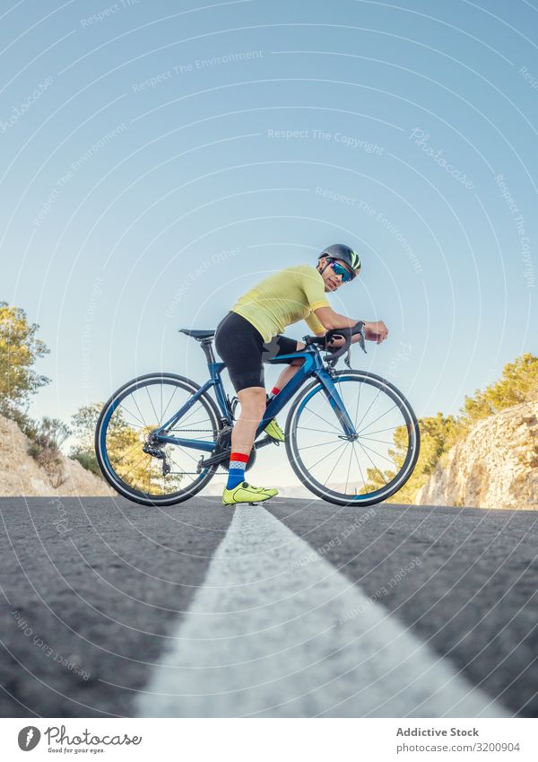 man resting while riding a bicycle on a mountain road Leisure and hobbies Athlete Sports Ride Bicycle Racing sports Man Motorcycling Exterior shot Speed Street